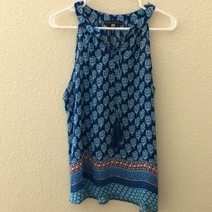Blue sleeveless blouse.